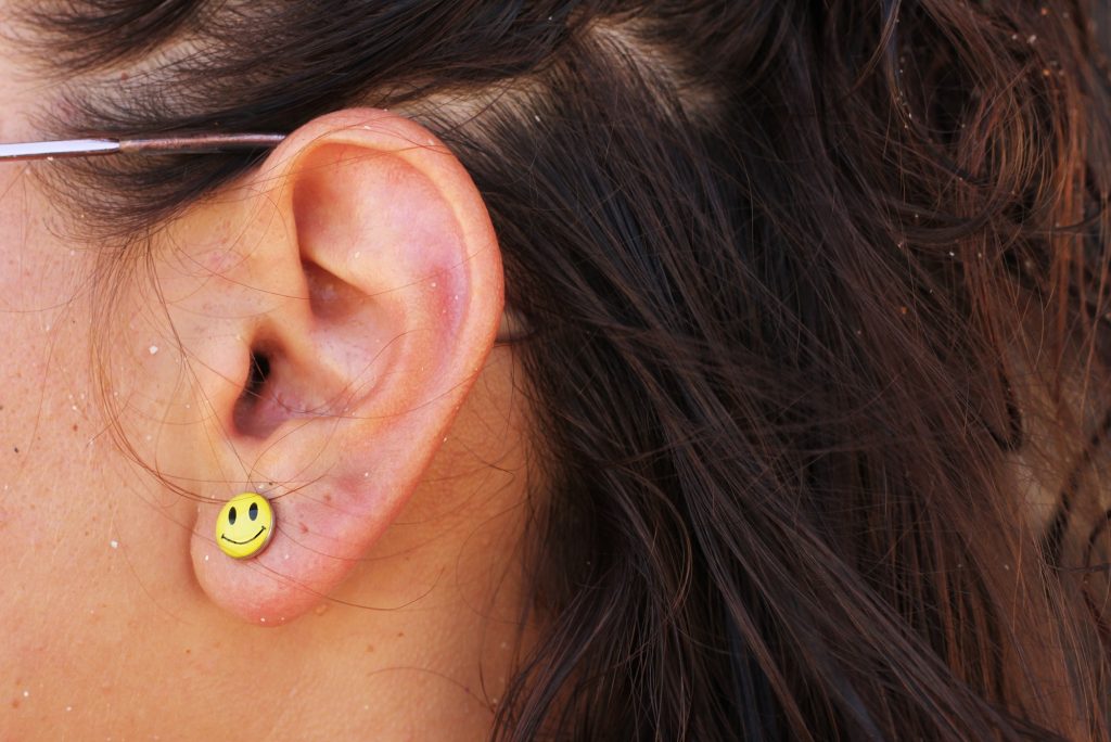 Smile earring on the ear of a woman