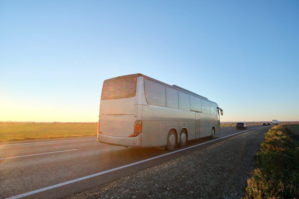 Intercity passenger bus driving on highway in evening